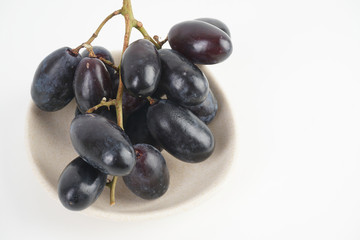 Fresh grape fruits plated over the white background