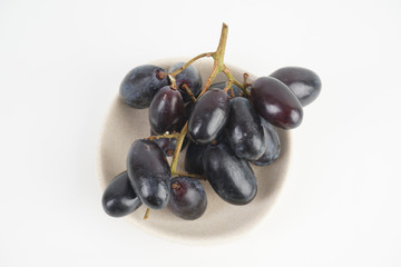 Fresh grape fruits plated over the white background