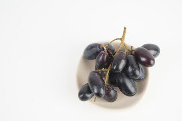 Fresh grape fruits plated over the white background
