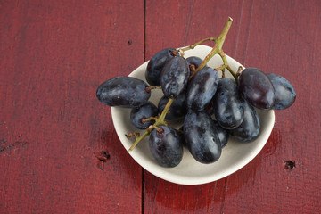 Fresh grape fruits plated over the wooden background