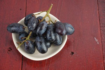 Fresh grape fruits plated over the wooden background