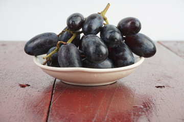 Fresh grape fruits plated over the wooden background