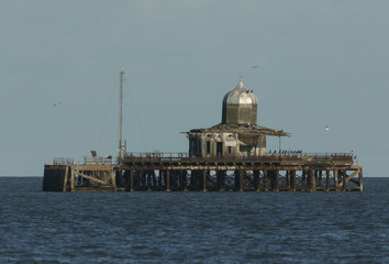 A derelict pier lying abandoned off the Kent coast of Herne bay England. It is being used by...