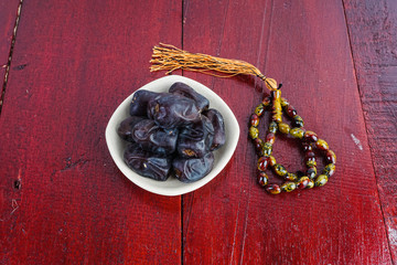 Dates fruit over an old brown table. Selective focus