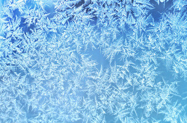 Ice flowers frozen texture on window background