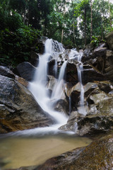 Obraz premium Beautiful waterfall view in the jungle. Long exposure image of water
