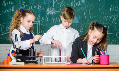 Little children. Science. Little kids earning chemistry in school lab. Chemistry science. biology experiments with microscope. Little girls and boy in lab. Focused on exam