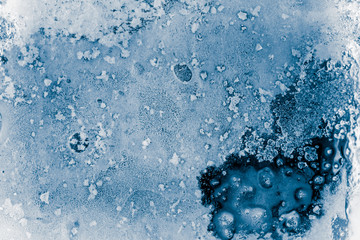 Textured, blue toned, ice block surface with hoar frost, background.