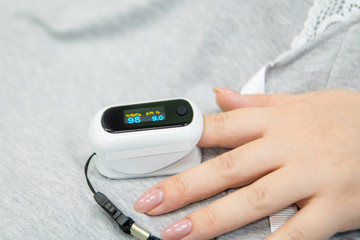 Hand of seriously ill with oxygen saturation sensor saturation. concept of illness