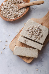 Sunflower halva with seeds  on wooden background. Festive Oriental delicacy