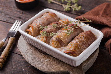 Grilled meat rolls wrapped in strips of bacon. Pork roll filled