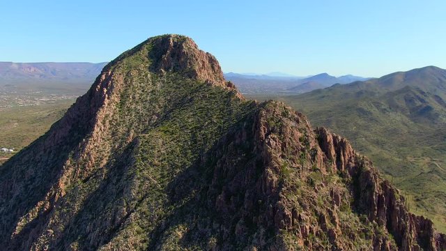 Aerial rotating around rocky cactus mountain top