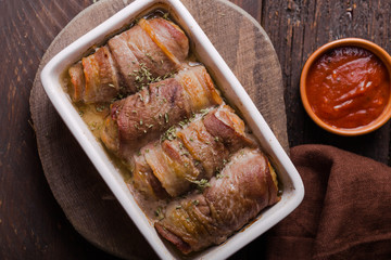 Grilled meat rolls wrapped in strips of bacon. Pork roll filled