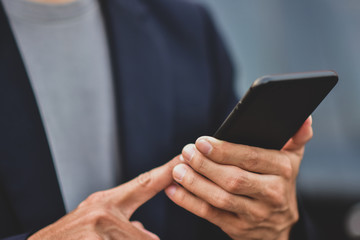 Business people holding cell phone or mobile smart phone technology communication