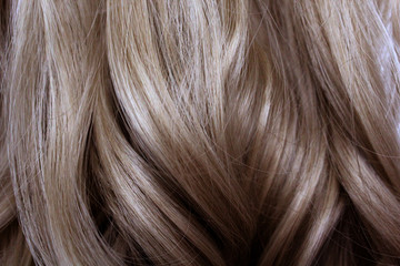 Fototapeta premium Beautiful blond wavy hair. Natural long hair for background.
