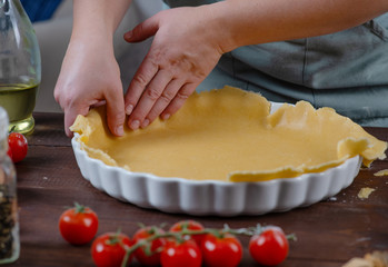the chef prepares a quiche with tomatoes