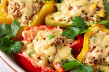 Tasty stuffed bell peppers in baking dish, closeup