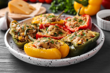 Tasty stuffed bell peppers on grey wooden table