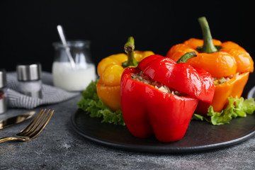 Tasty stuffed bell peppers on grey table