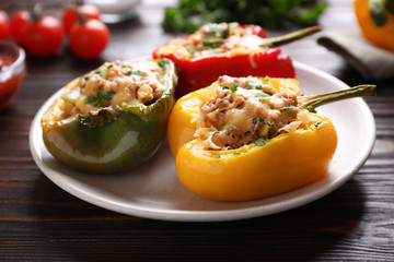 Tasty stuffed bell peppers on wooden table, closeup
