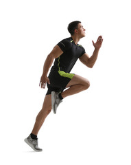 Athletic young man running on white background, side view