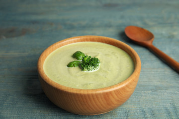 Delicious broccoli cream soup served on blue wooden table