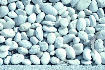 Small white pebbles texture close-up. Natural background blue color toned