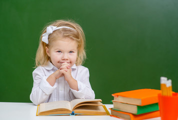 a cute child is reading a book