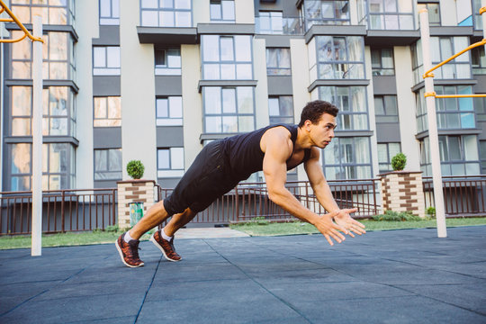 Strong muscular men are working out in gym. Cross fit training. Making push-ups