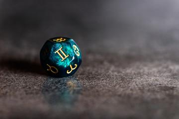 Astrology Dice with zodiac symbol of Gemini May 21 - Jun 20 on dark background