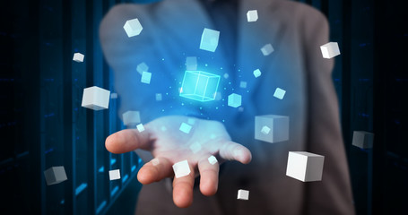 Person holding hologram projection displaying white cubes in server room