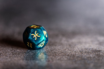 Astrology Dice with zodiac symbol of Pisces Feb 19 - Mar 20 on dark background