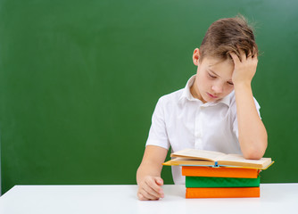 a tired child is reading a book