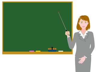 指し棒で説明するグレーのスーツの女性講師　黒板