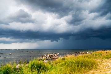 Dark grey storm clouds moving over ocean