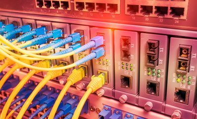 Fiber Optic cables connected to an optic ports and Network cables connected to ethernet ports