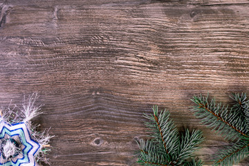 Fototapeta premium Christmas background. brown wooden drawing and vibrant green branches