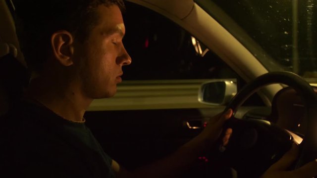 Man drives a car and falls asleep