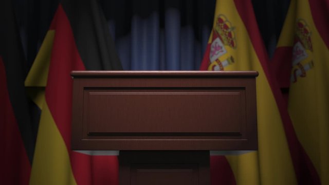 Flags of Germany and Spain and speaker podium tribune. Political event or negotiations related conceptual 3D animation
