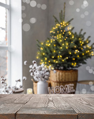 Empty wooden surface and blurred view of room decorated for Christmas