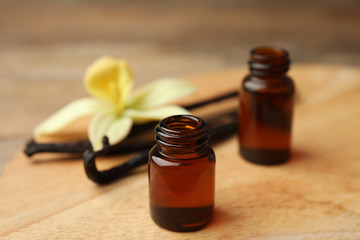 Aromatic homemade vanilla extract on wooden table, closeup
