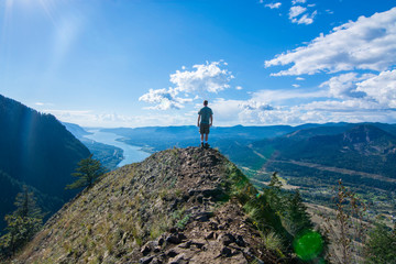 Adventurous man standing on top of Munra Point.