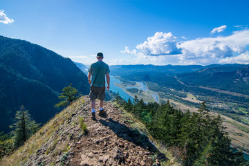 Fototapeta premium Adventurous man standing on top of Munra Point.