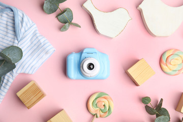 Flat lay composition with toy camera on pink background. Future photographer
