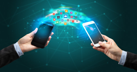 Two mobile phones syncing applications concept