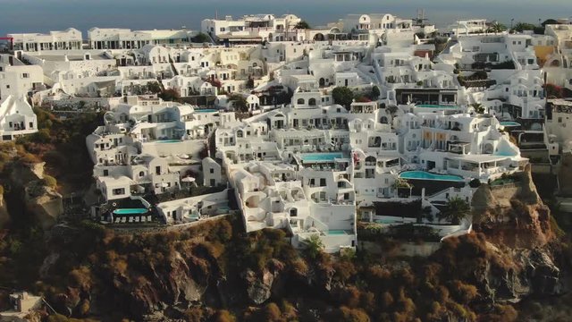 Aerial footage - White houses and blue domes of Oia, Santorini.