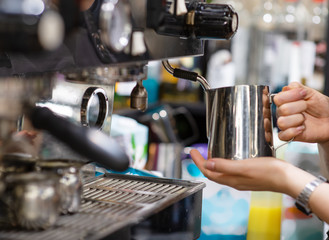 a Barista makes the coffee in the coffee machine