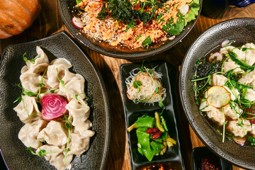 A buffet of Asian speicialties like Wonton Soup, dumplings, Poke Bowl and Asian salad.
