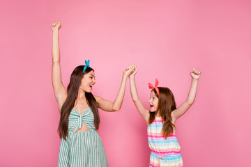 Profile side photo of excited two people holding hands screaming wearing bright dress skirt headbands isolated over pink background