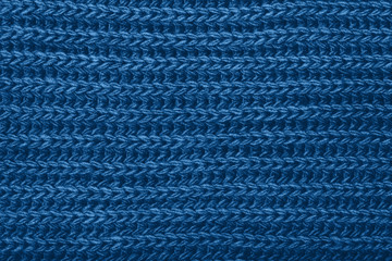 Knitted blue scarf texture. The concept of cozy, comfort, warm, softness or winter